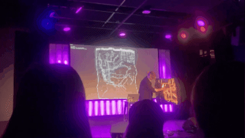 The performance from the audience, the map projected on the screen behind.